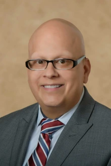 Portrait of Alejandro Vazquez with no hair.