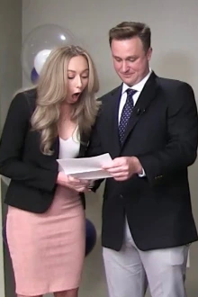 A man and woman look at the woman's Match Day letter.
