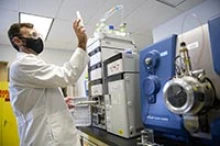 James Galligan, PhD, looks at a sample specimen before it’s processed in his UArizona College of Pharmacy lab. (Photo: Kris Hanning/University of Arizona Health Sciences)