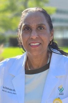 Smiling Black woman wearing a white coat