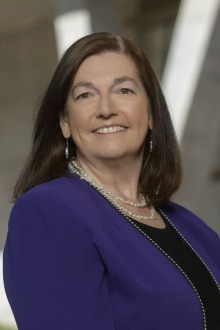 Portrait of Professor Cheryl Lacasse, a smiling light-skinned woman with long dark hair. 