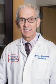 Portrait of Dr. Marvin J. Slepian wearing a white medical coat and tie. 