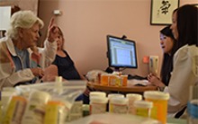 UArizona College of Pharmacy’s Jeannie Lee, PharmD (far right), participates in a medication review appointment with an elderly woman and her daughter-in-law. The average number of prescription drugs filled annually increases from 13 for ages 50-64 to 20 for ages 65-79 and 22 for those above age 80, according to a University of Georgetown health policy study. (Photo: University of Arizona Health Sciences, David Mogollon)
