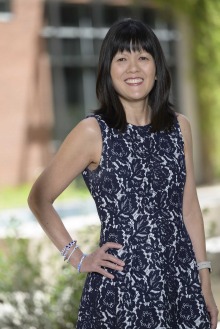 Portrait of Nicole Yuan, PhD, MPH, standing outside of the Zuckerman College of Public Health building.