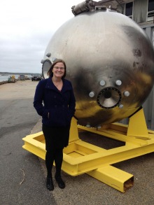 Bonnie Hurwitz, PhD, is pictured at Woods Hole Oceanographic Institution next to the main chamber for the Alvin submersible, which collects samples from the deepest parts of the ocean not accessible to people.