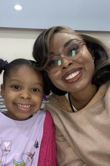 Black woman and daughter smiling