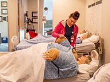 A student examines a mannequin at the UArizona College of Nursing's Gilbert Simulation Suite at its Gilbert, Arizona, campus. (Photo: University of Arizona College of Nursing)