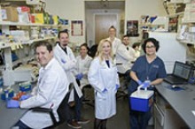 Melissa Herbst-Kralovetz, PhD, with her research team inside the lab at the Phoenix Biomedical Campus. (Photo: Kris Hanning/University of Arizona Health Sciences)