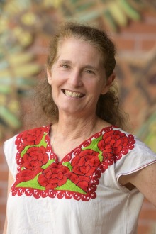 Portrait of Dr. Lisa Kiser, a smiling, light-skinned woman with long brown hair. 