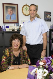 Marlys Witte, MD, and her son, Russ Witte, PhD, have worked together at the college since 2007. Marlys and her late husband, Chuck Witte, MD, pictured on the wall, were among founding faculty for the College of Medicine – Tucson’s Department of Surgery.