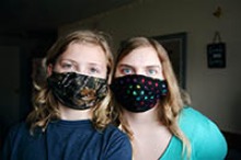 Young women demonstrate wearing of homemade masks. Not all materials and designs offer the same protection, UArizona researchers found.