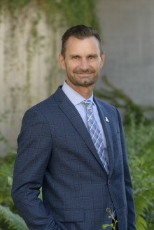 Man wearing a blue suit smiling